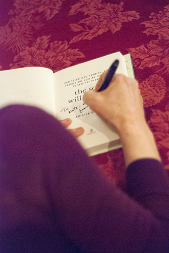 Photo of Kristin Ohlson signing a copy of her book at Powell's - Photo by Kristin Beadle